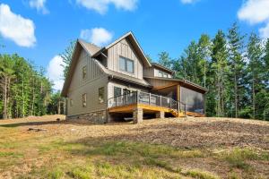 a large house on a hill in the woods at Higher Ground at Lake James in Nebo