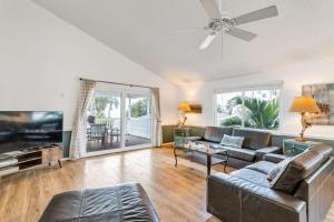 a living room with a couch and a flat screen tv at Beach Trail Bungalow Triplex in Clearwater Beach