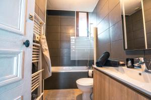 a bathroom with a toilet and a sink and a tub at Maison de ville envoutante, expérience unique ! in Nozay +27 photos