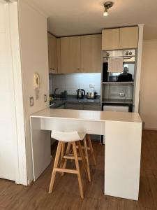 a kitchen with a large white island in a room at Apart Lyon Suite in Santiago +99 photos
