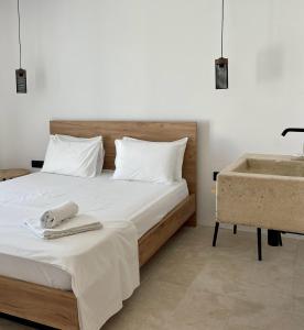 a bedroom with a bed and a tub and a sink at Psili Ammos in Mylopotas