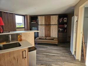 a kitchen with a sink and a counter top at Studio cosy in Veyrins +7 photos