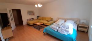 a living room with a bed and a couch at Apartament w centrum Pobierowa blisko plaży in Pobierowo