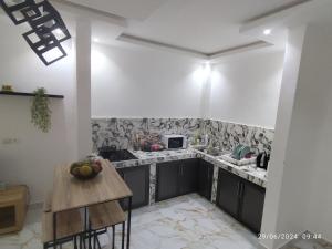 a kitchen with a sink and a counter top at Appartement meublé Thiès in Thiès +4 photos
