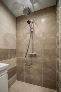 a shower with a shower head in a bathroom at Апартамент за гости НЕЛИТА in Varshets