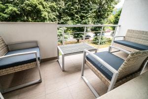 a balcony with two chairs and a table and chairs at Апартамент за гости НЕЛИТА in Varshets