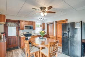 a kitchen with a table and a black refrigerator at Countryside Biggsville Home with Yard, Dogs Welcome! in Biggsville
