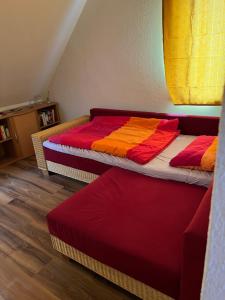 two beds with colorful sheets in a room at Kleine Bauernhof-Wohnung im Stadtbusbereich in Coburg