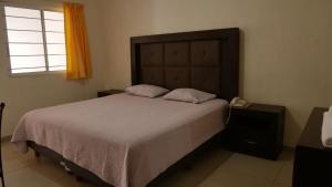 Postel nebo postele na pokoji v ubytování Hotel Insurgentes Express