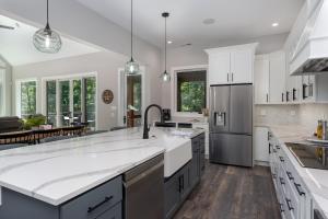 a large kitchen with white cabinets and a large island at The Creeks of Serendipity in Black Mountain