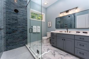 a bathroom with a glass shower and a sink at The Creeks of Serendipity in Black Mountain +48 photos