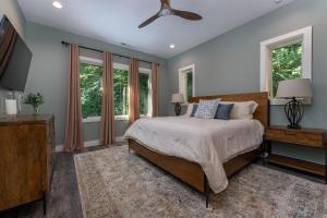 a bedroom with a bed and a ceiling fan at The Creeks of Serendipity in Black Mountain