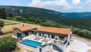 an aerial view of a house with a swimming pool at Villa Horto with Heated Pool & Sauna in Livade