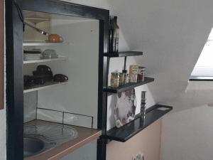 a kitchen with a shelf with a sink in it at Ferienwohnung "Unter der Löwenburg" in Gerolstein