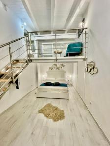 a bedroom with a bunk bed and a staircase at Rachele Boutique Apartments in Agropoli