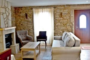 a living room with a couch and a fireplace at Casa Grille in Cee
