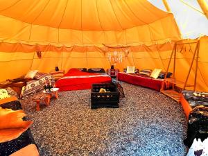 a room with a tent with a fire in it at Teepee Camp Lounky in Chodouny