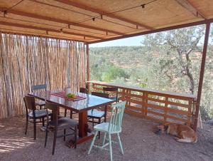a table and chairs and a dog laying on a patio at Wishne Glamping Agriturismo in tende Bisceglie in Bisceglie +93 photos