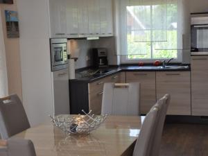 a kitchen with a table with a glass bowl on it at Holiday home Robbenplatte House 5 in Burhave