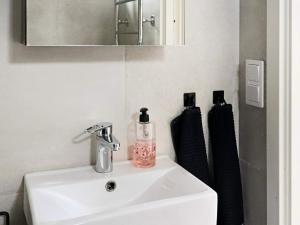 a bathroom with a sink and a mirror at 4 star holiday home in VARBERG in Varberg