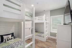 a room with two bunk beds and a window at NH387B Ocracoke Cottage in Nags Head +32 photos