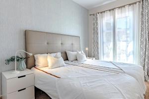 a bedroom with a large white bed with a window at Tenerifeopenhome Costa Adeje comfort apartment 3 pools in Adeje +59 photos