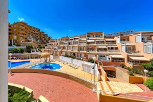 an apartment complex with a swimming pool and buildings at Tenerifeopenhome Costa Adeje comfort apartment 3 pools in Adeje