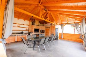 a dining room with a table and chairs at Vila Ghita in Vişeu de Jos