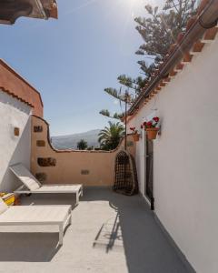 a balcony with benches and a view of the ocean at Casa Lupe in Santa Úrsula +32 photos