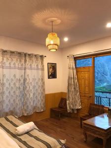a bedroom with a bed and a table and a window at The Shangbar in Jispa