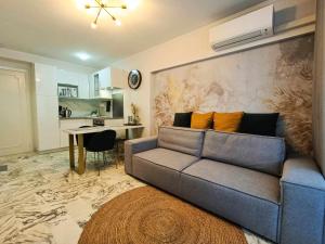 a living room with a couch and a table at La Résidence Fleuries - Plage in Cannes +9 photos