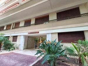 a building with a balcony with plants in front of it at La Résidence Fleuries - Plage in Cannes