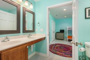 a bathroom with two sinks and a mirror at NH333 Capt Brad's in Nags Head +57 photos