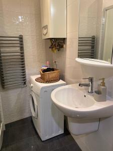 a bathroom with a washing machine and a sink at Silwer ROOM in Kraków +19 photos