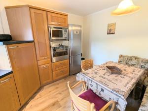 a small kitchen with a table and a refrigerator at Ferienwohnung in Potsdam
