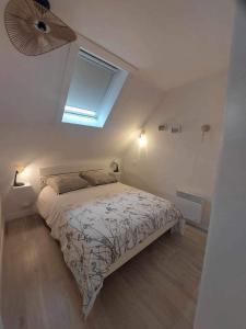 a bedroom with a bed and a ceiling fan at Maison Bretonne avec piscine in Marzan +50 photos