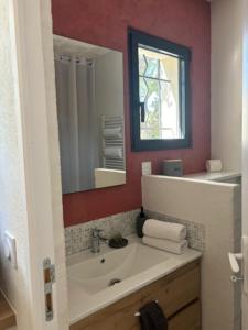 a bathroom with a sink and a mirror at Les Gîtes W''elles''come in Cotignac