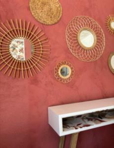 a wall with mirrors on a red wall at Les Gîtes W''elles''come in Cotignac