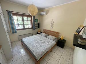 a bedroom with a bed and a window at pines & sea in Sofiko