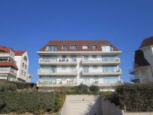 a tall apartment building with a garage in front of it at Zoutezoute in Knokke-Heist