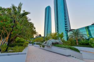 a walkway in a city with two tall buildings at Luxury Seaview Penthouse Harbour Heights in Manama