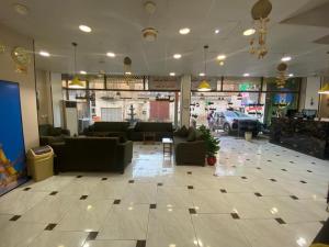 a lobby with couches and chairs in a store at فندق عسل - Asal Hotel in Baghdād