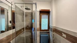 a bathroom with a glass shower with a toilet at A casa di Martina - CIR 0051 in Aosta +33 photos