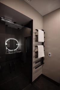 a bathroom with a shower and a mirror and towels at the reid hotel in Vanderhoof