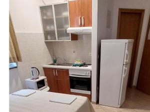 a small kitchen with a refrigerator and a sink at Apartments Villa Katarina in Makarska +97 photos