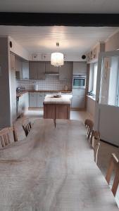 a large kitchen with a large wooden table and chairs at La Vie Est Belle in Kortemark