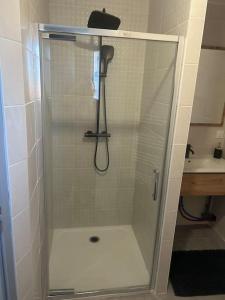 a shower with a glass door in a bathroom at Belle villa avec terrasse in Pechbonnieu