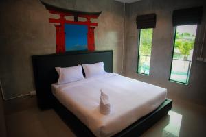 Postel nebo postele na pokoji v ubytování B-Cozy Hotel