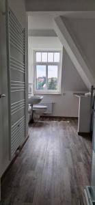 an attic room with a large window and a table at Ausblick Freital 2 in Freital