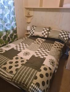 two beds in a room with a bedspread on them at Cozy Cardiff Cabin Retreat sleeps 6 by Aimee in Cardiff